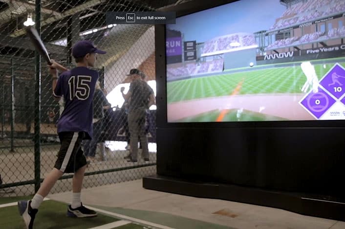 boy swinging baseball bat for vr game