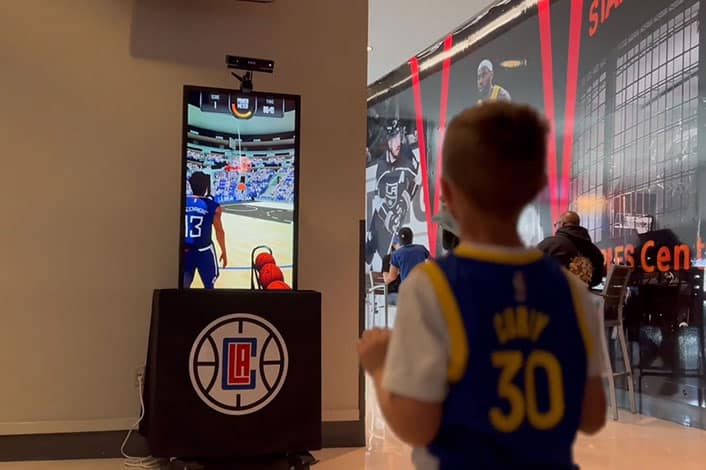 young boy playing vr basketball shot