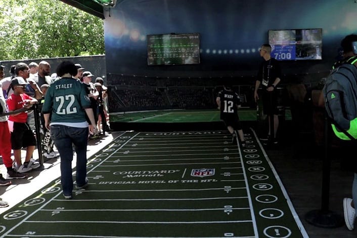 fans playing in interactive football field