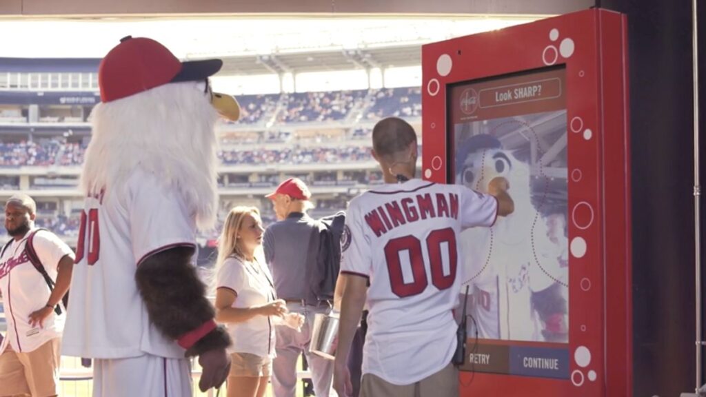 baseball fan uses digital touch screen at stadium